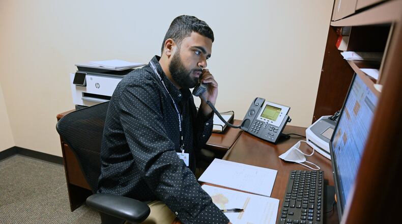 Epidemiologist Curtis Sarkar checks in via phone at Gwinnett Board of Health Administration Center in Lawrenceville on May 7, 2020. Georgia is beefing up its contact tracing program with the hope that it can tamp down on community spread. But contact tracing has limitations, especially as new cases spike. (Hyosub Shin / Hyosub.Shin@ajc.com)