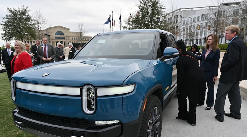 December 16, 2021 Atlanta - Guests look at Rivian R1T electric truck during a press conference at Liberty Plaza across from the Georgia State Capitol in Atlanta on Thursday, December 16, 2021. Electric vehicle maker Rivian on Thursday confirmed its plans to build a $5 billion assembly plant and battery factory in Georgia, which Gov. Brian Kemp called Òthe largest single economic development project ever in this stateÕs history.Ó (Hyosub Shin / Hyosub.Shin@ajc.com)