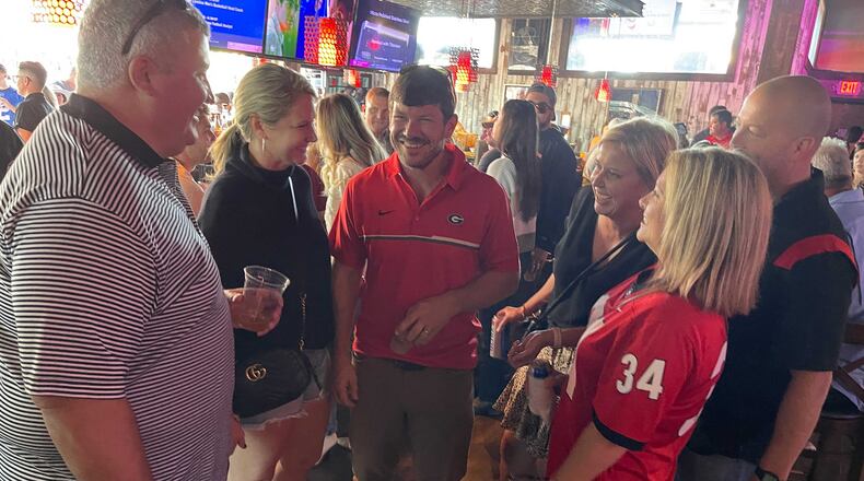 Georgia fans from Douglas, including Matt Henessey, Liz Grantham and Walt Stewart, were among hundreds of the Bulldogs' fans gathered at Jason Aldean’s Kitchen and Rooftop Bar on Friday in Nashville, Tenn. (Photo by Chip Towers/ctowers@ajc.com)