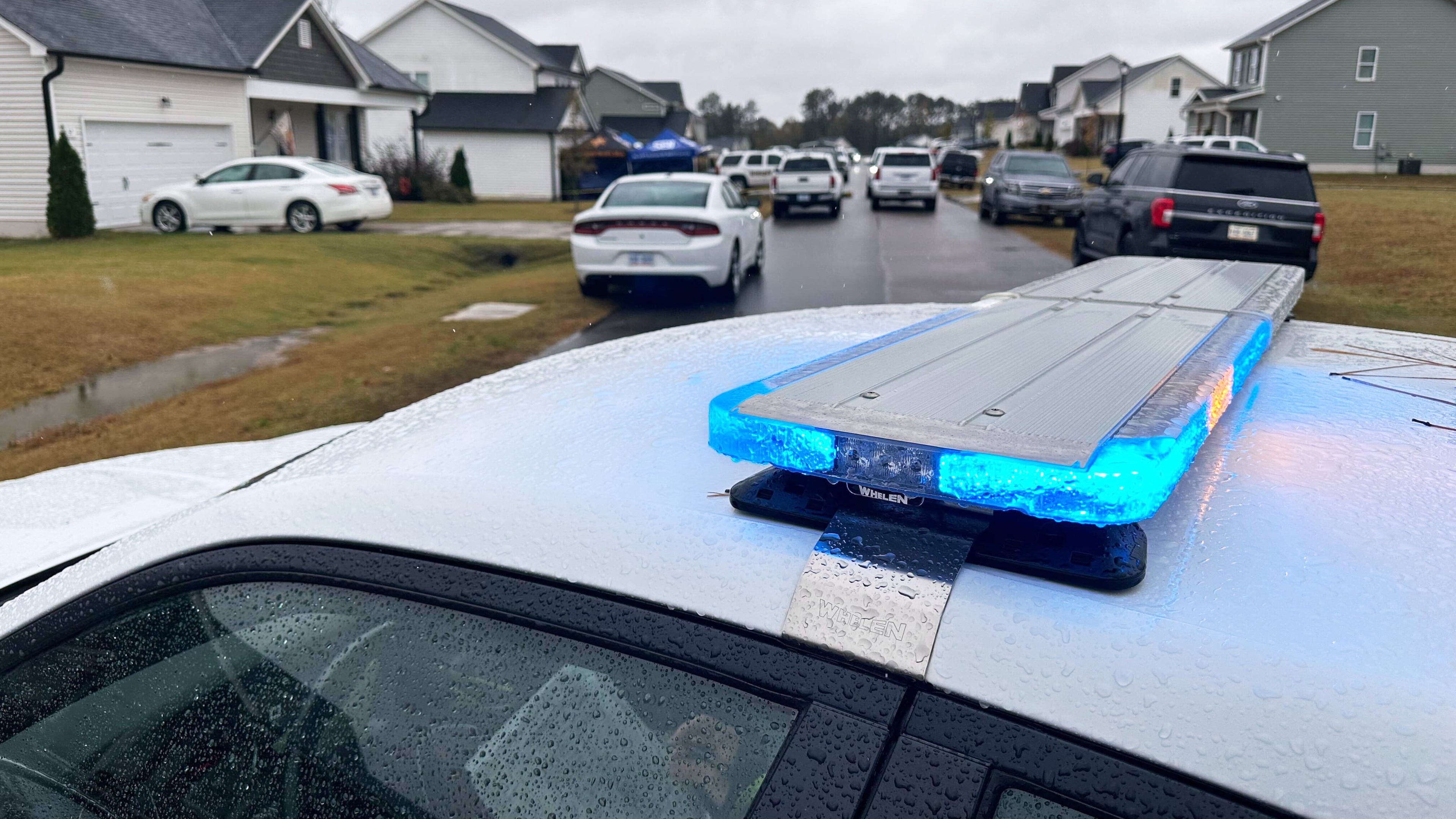 Law enforcement vehicles block the road to Wellington Delano Dickens III's home, where remains were found after Dickens told authorities he had killed four of his children, in Zebulon, N.C., on Tuesday, Oct. 28, 2025. (AP Photo/Allen G. Breed)