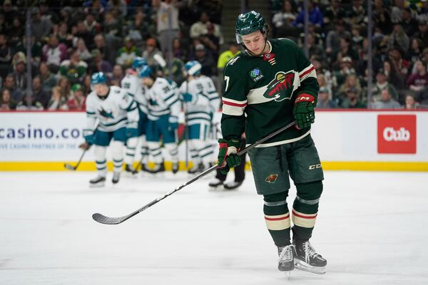 Minnesota Wild defenseman Brock Faber (7) skates after a goal scored by San Jose Sharks center Macklin Celebrini (71) during the second period of an NHL hockey game, Wednesday, April 9, 2025, in St. Paul, Minn. (AP Photo/Abbie Parr)
