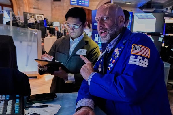 Trader Niall Pawa, left, and specialist Meric Greenberg work on the floor of the New York Stock Exchange, Monday, May 12, 2025. (AP Photo/Richard Drew)