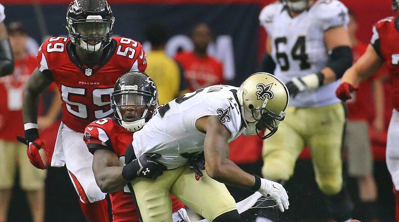 Falcons safety William Moore strips Saints wide receiver Marques Colston causing a fumble recovered by the Falcons in overtime in their NFL football game on Sunday, Sept. 7, 2014, in Atlanta. Falcons linebacker Joplo Bartu (left) recovered the fumble. The Falcons went on to kick a field goal to win the game 37-34. CURTIS COMPTON / CCOMPTON@AJC.COM