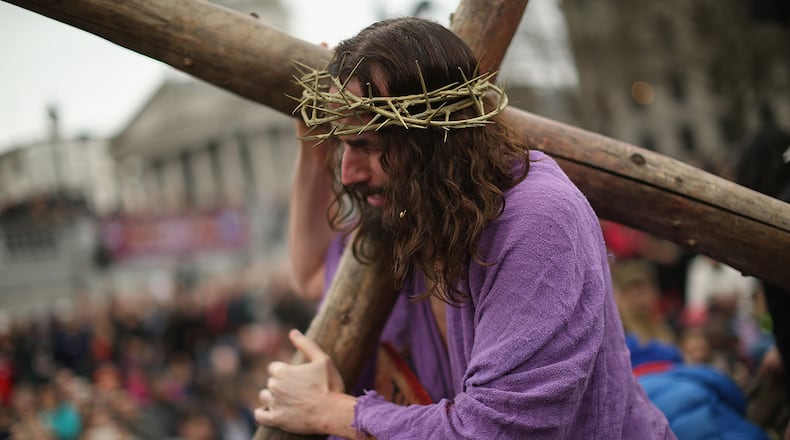Actor James Burke-Dunsmore playing Jesus drags the cross during the Wintershall's 'The Passion of Jesus' production on Good Friday in Trafalgar Square on April 3, 2015 in London, England. Good Friday is a Christian religious holiday before Easter Sunday, which commemorates the crucifixion of Jesus Christ on the cross. The Wintershall's theatrical production of 'The Passion of Jesus' includes a cast of 100 actors, horses, a donkey and authentic costumes of Roman soldiers in the 12th Legion of the Roman Army.  (Photo by Dan Kitwood/Getty Images)