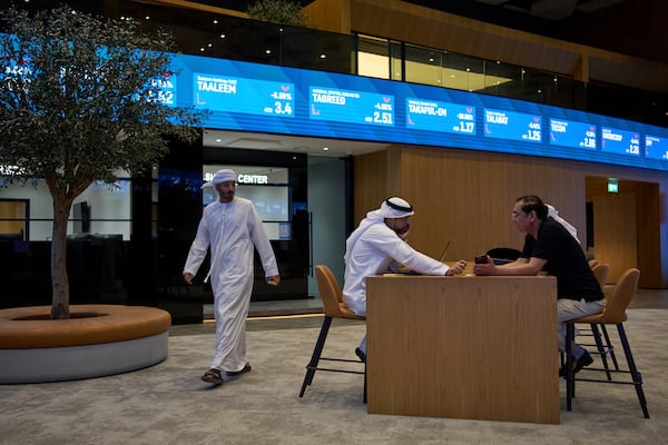 Emiratis are seen in the Dubai Financial Market in Dubai, United Arab Emirates, Monday, April 7, 2025. (AP Photos/Fatima Shbair)