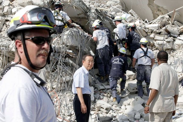 FILE - U.N. Secretary-General Ban Ki-moon , center, visits the collapsed UN headquarters during his visit to Port-au-Prince, Jan. 17, 2010. (AP Photo/Francois Mori, File)