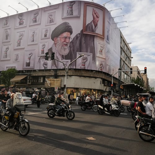 FILE - Motorbikes drive past a billboard showing the late Iranian Supreme Leader Ayatollah Ali Khamenei, who was killed in the U.S. and Israel strikes on Feb. 28, in downtown Tehran, Iran, Wednesday, May 6, 2026. (AP Photo/Vahid Salemi, File)