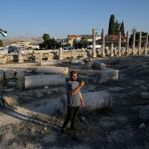 A Palestinian visitor takes a photo at the Roman historical site in the West Bank town of Sebastia Thursday, Nov. 20, 2025. (AP Photo/Nasser Nasser)