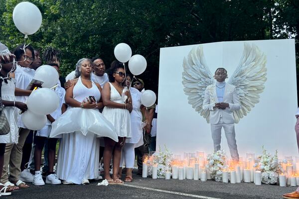 Family members of Jabari Peoples hold balloons at a candlelight vigil in Homewood, Ala., Monday, June 30, 2025. Peoples, 18, was shot and killed by police at the spot at a Homewood soccer field complex on Monday, June 23. (AP Photo/Kim Chandler)