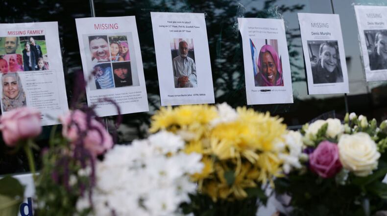 Posters close to Grenfell Tower in west London depict missing persons after a fire engulfed the 24-story building on Wednesday morning.