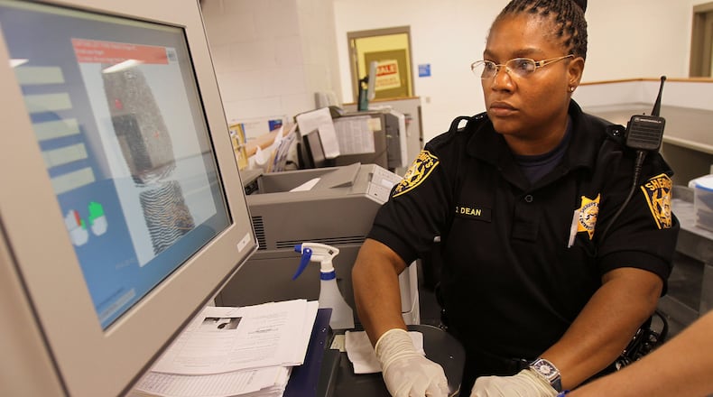 Lawrenceville: Deputy D. Dean processes an inmate at the Gwinnett County Jail, which participates in the federal 287(g) immigration enforcement program. Vino Wong/vwong@ajc.com