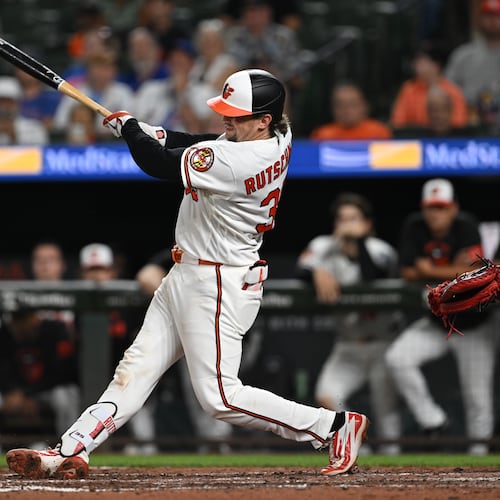 Baltimore Orioles catcher Adley Rutschman (35) follows through on a two run double against the Chicago Cubs in the seventh inning of a baseball game on Tuesday, July 7, 2026 in Baltimore, Md. (AP Photo/Gail Burton)
