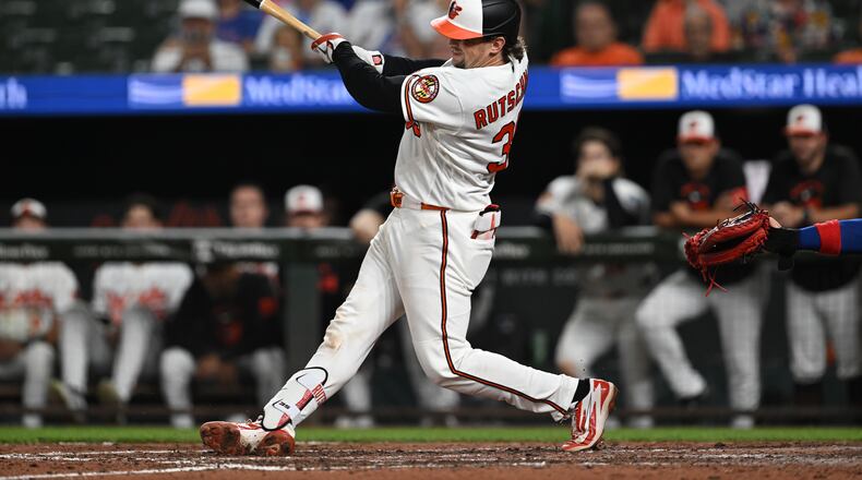 Baltimore Orioles catcher Adley Rutschman (35) follows through on a two run double against the Chicago Cubs in the seventh inning of a baseball game on Tuesday, July 7, 2026 in Baltimore, Md. (AP Photo/Gail Burton)