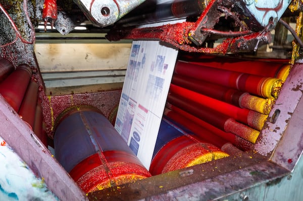The final Sunday run of The Atlanta Journal-Constitution print edition makes its way through the presses. (Arvin Temkar/AJC)
