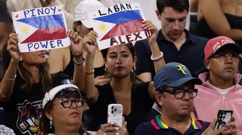 Fans of Alexandra Eala, of the Philippines, hold up signs during her match against Mary Stoiana, of the United States, in the first round of the U.S. Open tennis championships Tuesday, Sept. 1, 2026, in New York. (AP Photo/Adam Hunger)