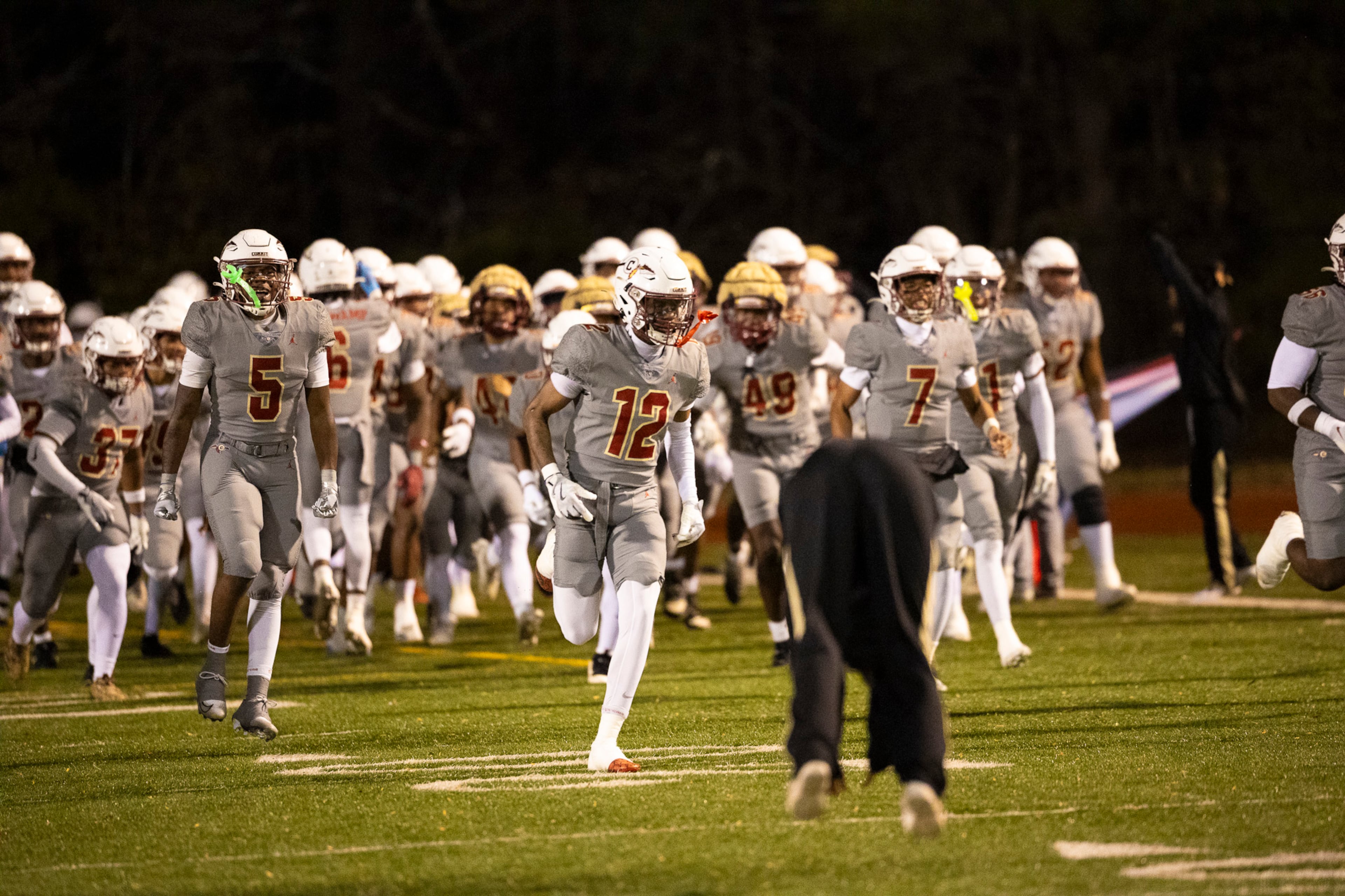 Creekside players run out during the first half of the class 4A semifinal against Kell at Creekside High School in Fairburn, GA on Friday, December 5, 2025. (Oscar Guevara Saenz for the AJC)