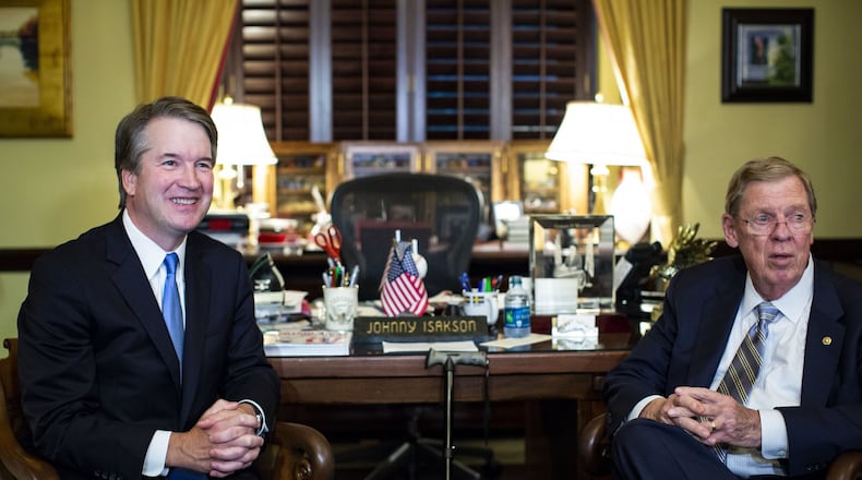 Judge Brett Kavanaugh, left, President Donald Trump’s Supreme Court nominee, meets with Republican U.S. Sen. Johnny Isakson of Georgia in July. (Al Drago/The New York Times)