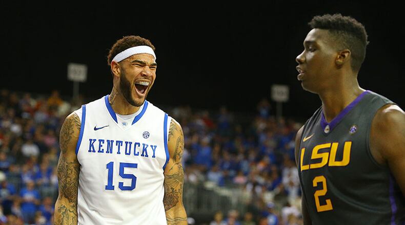 Kentucky forward Willie Cauley-Stein celebrate a slam over LSU forward Jordan Mickey while LSU forward Johnny O'Bryant III looks during the second half of an 85-67 Kentucky win over the Tigers in their SEC quarterfinals matchup Saturday, March 15, 2014, at the Georgia Dome in Atlanta.