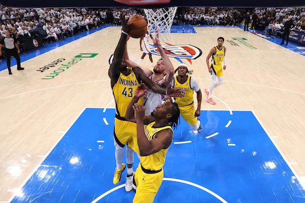 Oklahoma City Thunder forward Chet Holmgren (7), Indiana Pacers forward Pascal Siakam (43) and forward Aaron Nesmith (23) reach for the ball during Game 1 of the NBA Finals basketball series Thursday, June 5, 2025, in Oklahoma City. (Matthew Stockman/Pool Photo via AP)