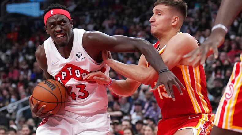 Raptors forward Pascal Siakam (43) drives to the basket as Hawks guard Bogdan Bogdanovic (13) defends during the first half in Toronto on Tuesday, April 5, 2022. (Nathan Denette/The Canadian Press via AP)