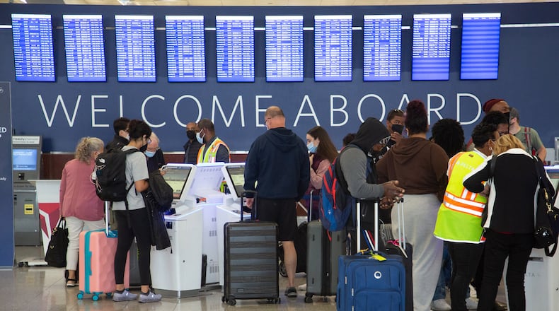 People wait in line at the Delta check-in at the South Terminal at the Hartsfield-Jackson International Airport in Atlanta on December 27, 2021 STEVE SCHAEFER FOR THE ATLANTA JOURNAL-CONSTITUTION