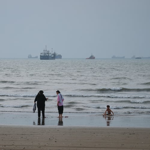 People spend time at a beach as commercial vessels are anchored in the Strait of Hormuz off Bandar Abbas, Iran, Wednesday, Sept. 2, 2026. (Razieh Poudat/ISNA via AP)