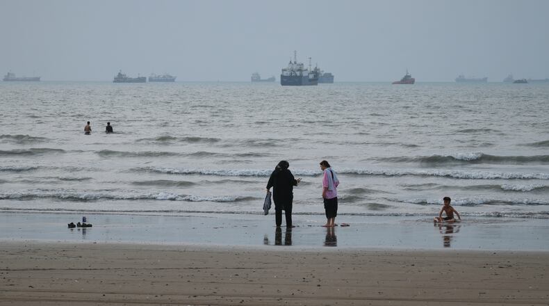 People spend time at a beach as commercial vessels are anchored in the Strait of Hormuz off Bandar Abbas, Iran, Wednesday, Sept. 2, 2026. (Razieh Poudat/ISNA via AP)