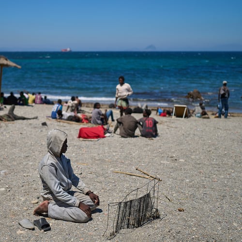 A migrant who crossed into Spain from Morocco prays on a beach in the Spanish enclave of Ceuta, Sunday, Aug. 2, 2026. (AP Photo/Bernat Armangue)
