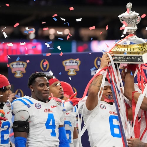 Mississippi platers and coach celebrate a win against Georgia after the Sugar Bowl NCAA college football playoff quarterfinal game, Friday, Jan. 2, 2026, in New Orleans. (AP Photo/Gerald Herbert)