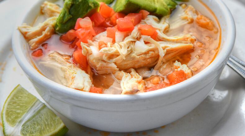 Taxco’s Sopa de Pollo garnished with avocado, chopped tomatoes and onions.
(Chris Hunt for The Atlanta Journal-Constitution)