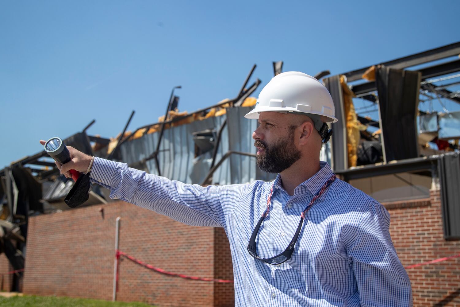 Newnan High School principal Chase Puckett surveys the damage at the school from an EF4 tornado. (Alyssa Pointer / Alyssa.Pointer@ajc.com)