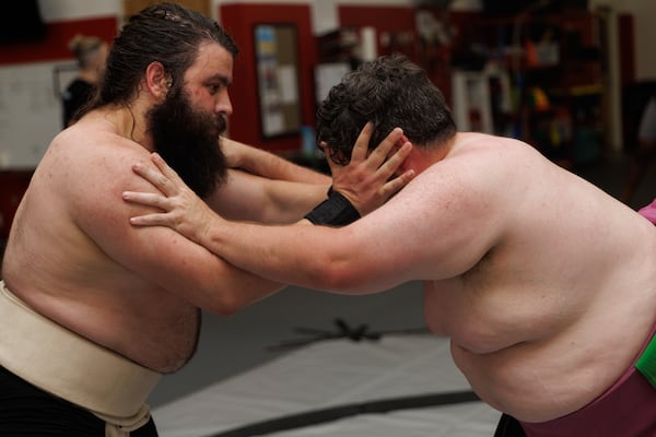 Johann Chancey (left) and Taylor Fordham wrestle during Black Dragon Beya sumo practice at Atlanta Kick in Atlanta, June 30, 2026. (Estela Muñoz/AJC)