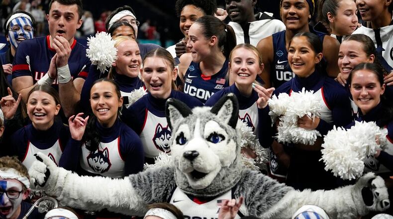 UConn cheerleaders celebrate after a college basketball game against Stanford in the semifinal round of the Women's Final Four NCAA tournament Friday, April 1, 2022, in Minneapolis. UConn won 63-58 to advance to the finals. (AP Photo/Eric Gay)