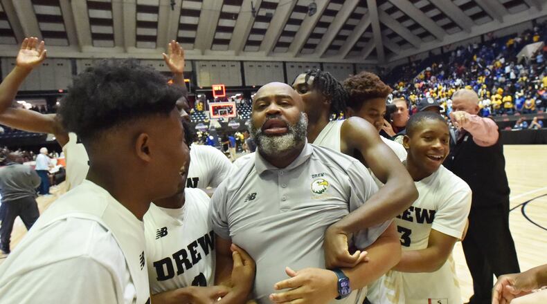 March 9, 2022 Macon - Drew Charter's head coach Kenyatta Bennett and players celebrate their victory over Warren County during the 2022 GHSA State Basketball Championship game at the Macon Centreplex in Macon on Wednesday, March 9, 2022. Drew Charter won 51-50 over Warren County. (Hyosub Shin / Hyosub.Shin@ajc.com)