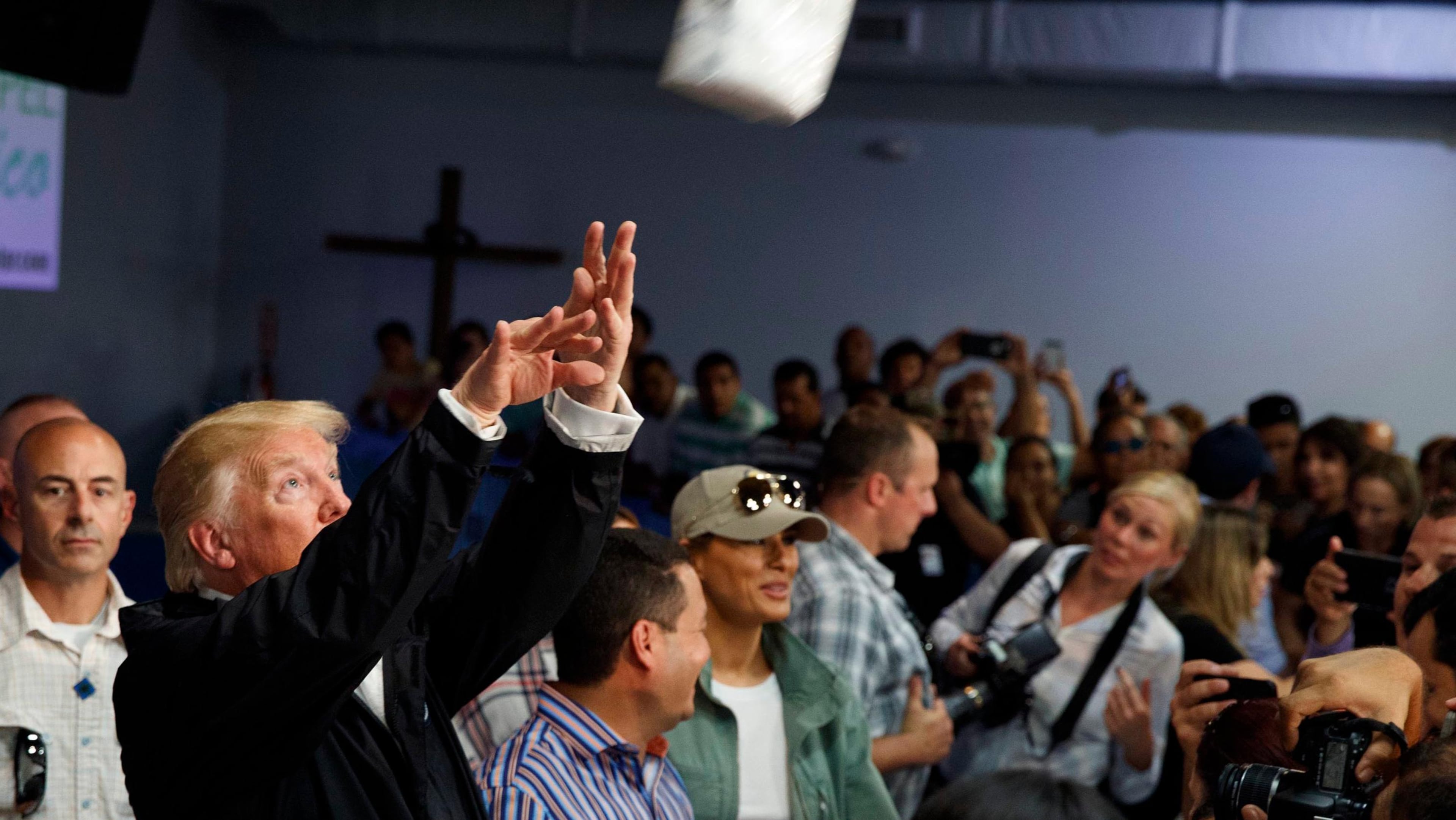President Donald Trump tosses paper towels into a crowd as he hands out supplies to people affected by Hurricane Maria at Calvary Chapel, Tuesday, Oct. 3, 2017, in Guaynabo, Puerto Rico. (Evan Vucci/AP)
