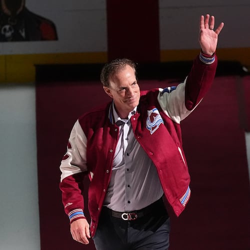 FILE - Joe Sakic, current general manager of the Colorado Avalanche as well as a member of the 1996 Stanley Cup Championship team, waves as he is introduced during a ceremony to mark the 30th anniversary of the win before an NHL hockey game against the Florida Panthers, on Dec. 11, 2025, in Denver. (AP Photo/David Zalubowski, File)