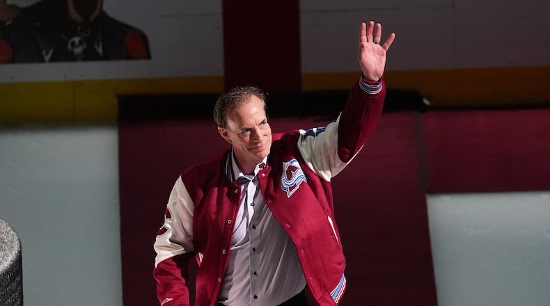 FILE - Joe Sakic, current general manager of the Colorado Avalanche as well as a member of the 1996 Stanley Cup Championship team, waves as he is introduced during a ceremony to mark the 30th anniversary of the win before an NHL hockey game against the Florida Panthers, on Dec. 11, 2025, in Denver. (AP Photo/David Zalubowski, File)