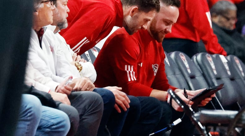 North Carolina States' Reed Vial, left, and Patrick Stacy, center, watch a replay during the first half of an NCAA college basketball game against Duke in Raleigh, N.C., Monday, March 2, 2026. (AP Photo/Karl DeBlaker)