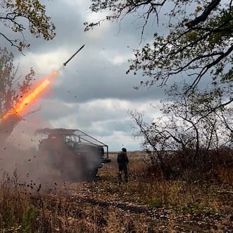 In this image made from video provided by the Russian Defense Ministry Press Service on Friday, Oct. 31, 2025, a Russian "Grad" self-propelled 122 mm multiple rocket launcher fires towards Ukrainian positions on an undisclosed location in Ukraine. (Russian Defense Ministry Press Service via AP)