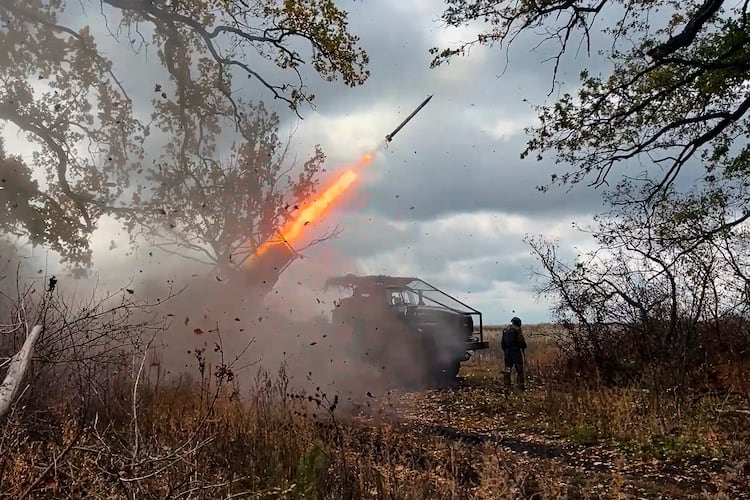 In this image made from video provided by the Russian Defense Ministry Press Service on Friday, Oct. 31, 2025, a Russian "Grad" self-propelled 122 mm multiple rocket launcher fires towards Ukrainian positions on an undisclosed location in Ukraine. (Russian Defense Ministry Press Service via AP)