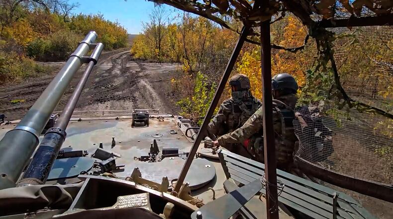 In this image made from video provided by the Russian Defense Ministry Press Service on Friday, Oct. 31, 2025, Russian servicemen attend a practice for sabotage operations behind enemy lines at a training ground on an undisclosed location. (Russian Defense Ministry Press Service via AP)