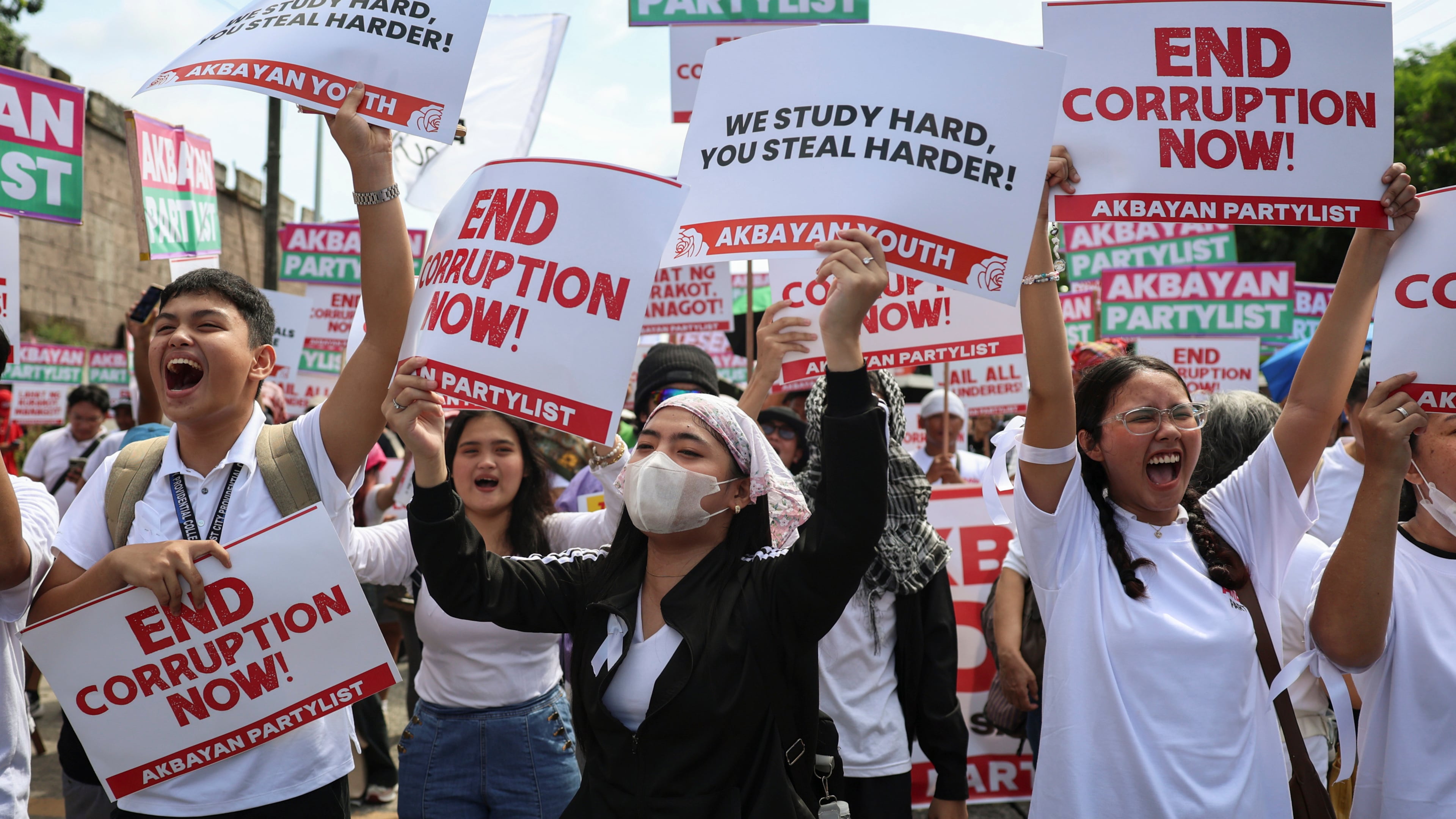 Protesters carry signs as they gather during a rally against government corruption at the EDSA People Power Monument in suburban Mandaluyong, east of Manila, Philippines, Sunday. Sept. 21, 2025. (AP Photo/Basilio Sepe)