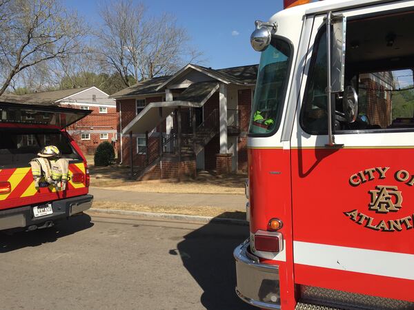An unconscious woman was pulled from a burning apartment in southeast Atlanta on Saturday , officials said. The fire was extinguished quickly and did not spread to surrounding units.