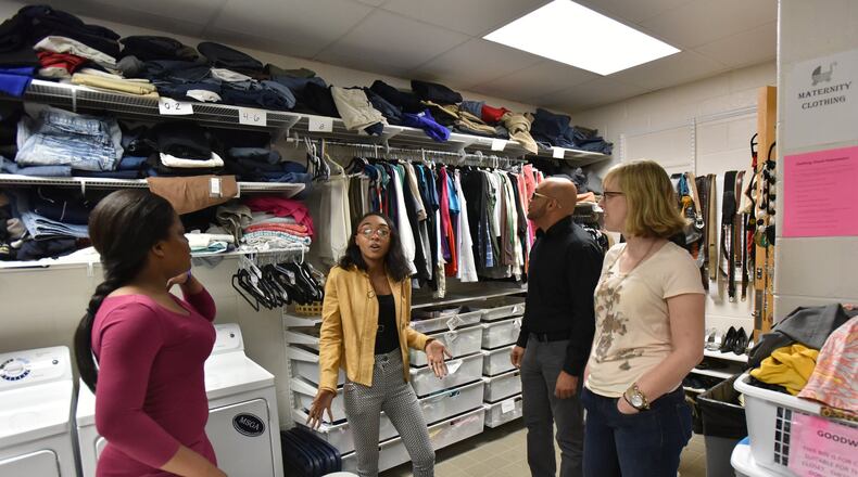 April 20, 2017 Marietta - R'moni Clark-Hudson (second from left), 17, shows the Graduate Marietta Student Success Center's Clothing Closet and Laundry area to visitors in Marietta High School on Thursday, April 20, 2017. Leigh Colburn has earned plaudits for her work with at-risk students at the year-old Graduate Marietta Student Success Center, an experiment housed inside the city's high school. Educators from across Georgia have made pilgrimages to the center, hoping to find ideas they can copy. HYOSUB SHIN / HSHIN@AJC.COM