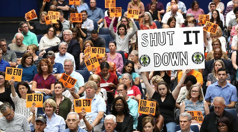 Many area residents hold signs in opposition as Cobb officials and environmental regulators hold a town hall and community forum in the wake of reports that Cobb and Fulton have high levels of carcinogenic gas on Monday, August 19, 2019, in Marietta. Curtis Compton/ccompton@ajc.com