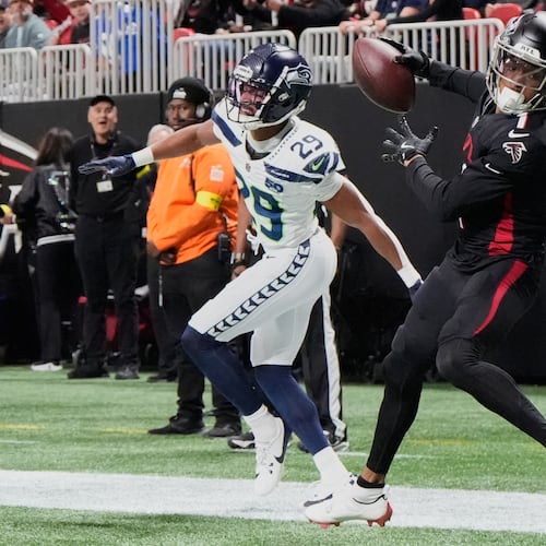 Atlanta Falcons wide receiver Darnell Mooney makes a catch against Seattle Seahawks cornerback Josh Jobe during the first half of an NFL football game, Sunday, Dec. 7, 2025, in Atlanta. (Mike Stewart/AP)