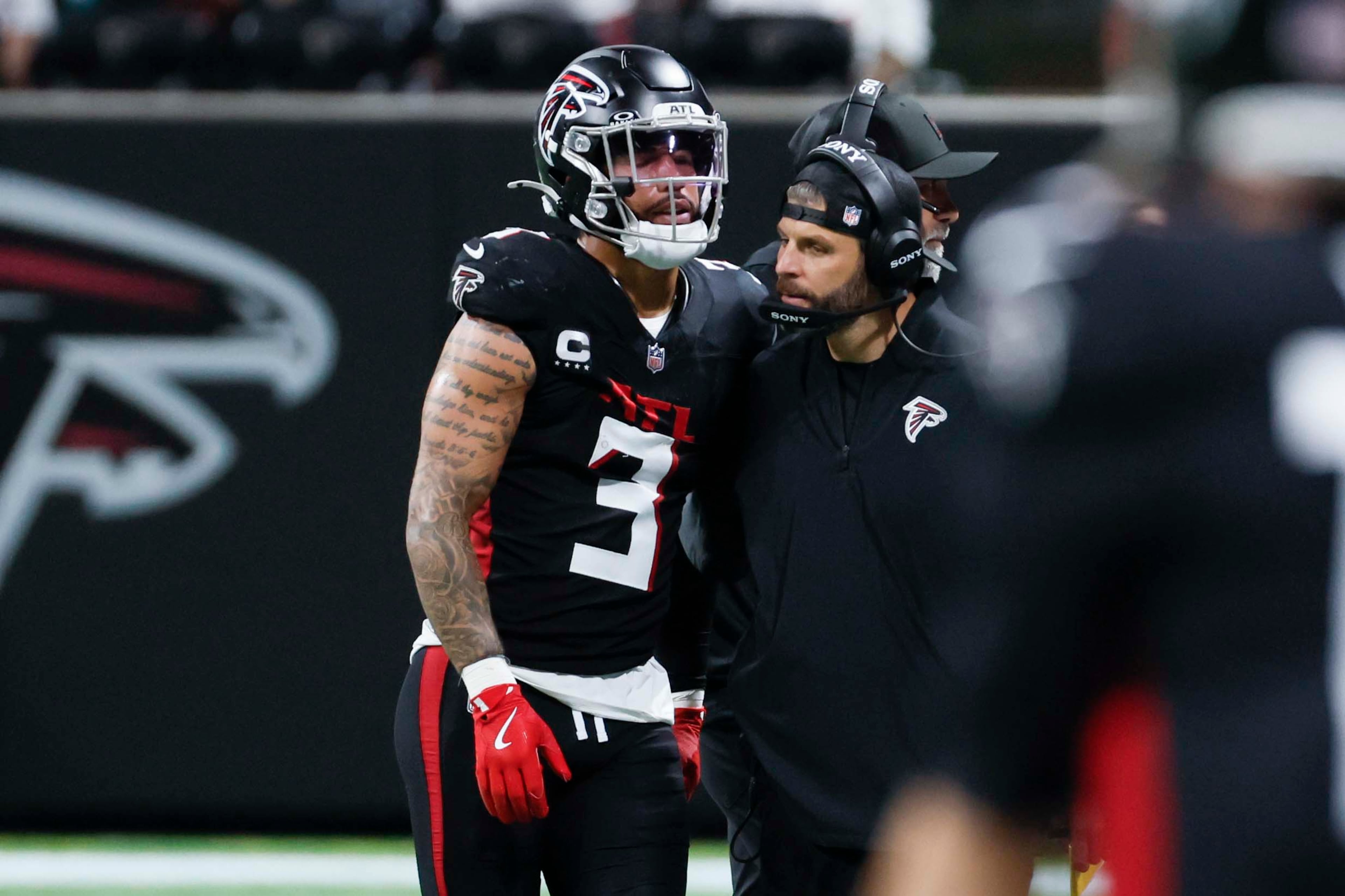 Atlanta Falcons free safety Jessie Bates III is helped by a Falcons staffer after a hit during the second half of an NFL game against the Miami Dolphins at Mercedes-Benz Stadium in Atlanta on Sunday, Oct. 26, 2025. (Miguel Martinez/AJC)