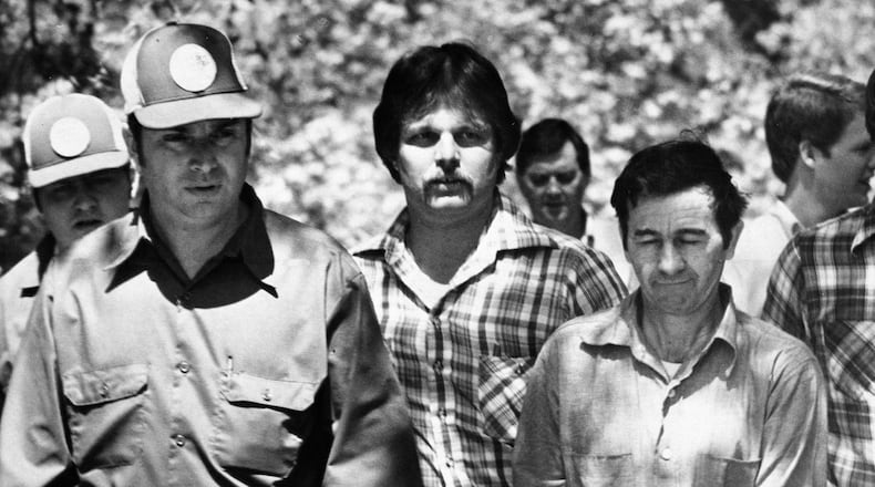 Donald H. “Pee Wee” Gaskins, in handcuffs, right, directed officers to an area in Florence County, South Carolina, April 17, 1978, where human bones were found. Gaskins is related to Elwyn Crocker Sr., charged with starving his children and burying their bodies in South Georgia. (AP Photo)