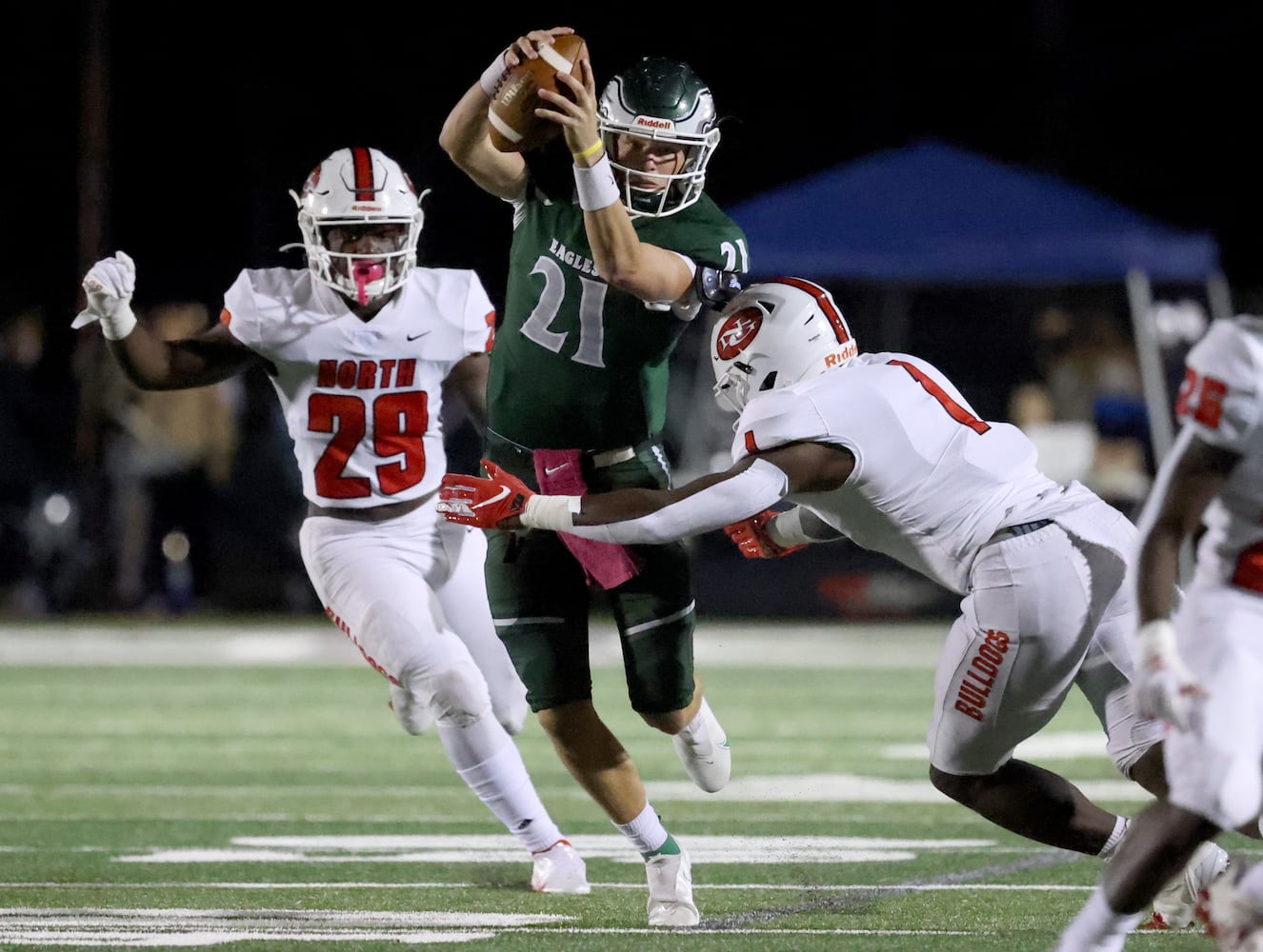 Collins Hill quarterback Sam Horn (21) runs against the defense of North Gwinnett linebacker Barrett Carter (1). JASON GETZ FOR THE ATLANTA JOURNAL-CONSTITUTION