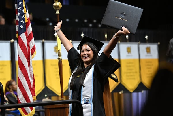 KSU graduate Stella Roman reacts after receiving her diploma during Kennesaw State University’s Spring 2026 Commencement at KSU Convocation Center on Wednesday, May 13, 2026, in Atlanta. KSU commencement ceremony for the College of Architecture and Construction Management, and the Michael J. Coles College of Business (Undergraduate Students in Entrepreneurship, Hospitality, Management, Marketing, and Professional Sales). (Hyosub Shin/AJC)